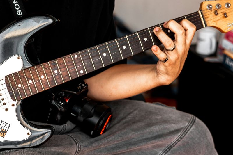 Person playing a guitar