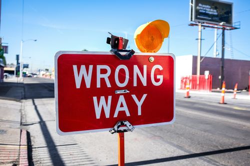 Wrong way sign representing mistake or incorrect decision